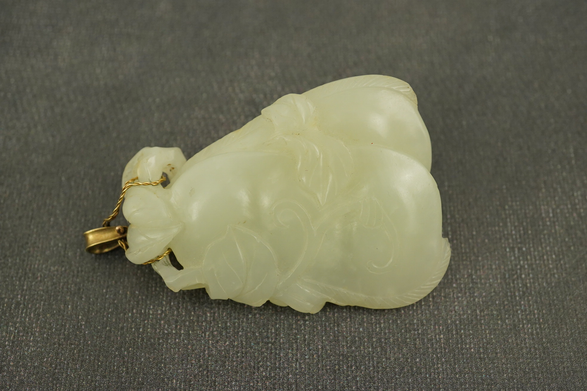 A Chinese pale celadon jade twin gourd pendant, 18th century